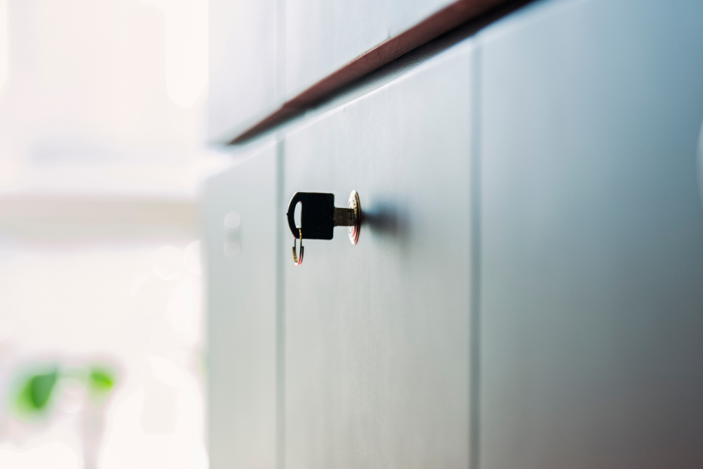 How do I fit a furniture lock to a cabinet?